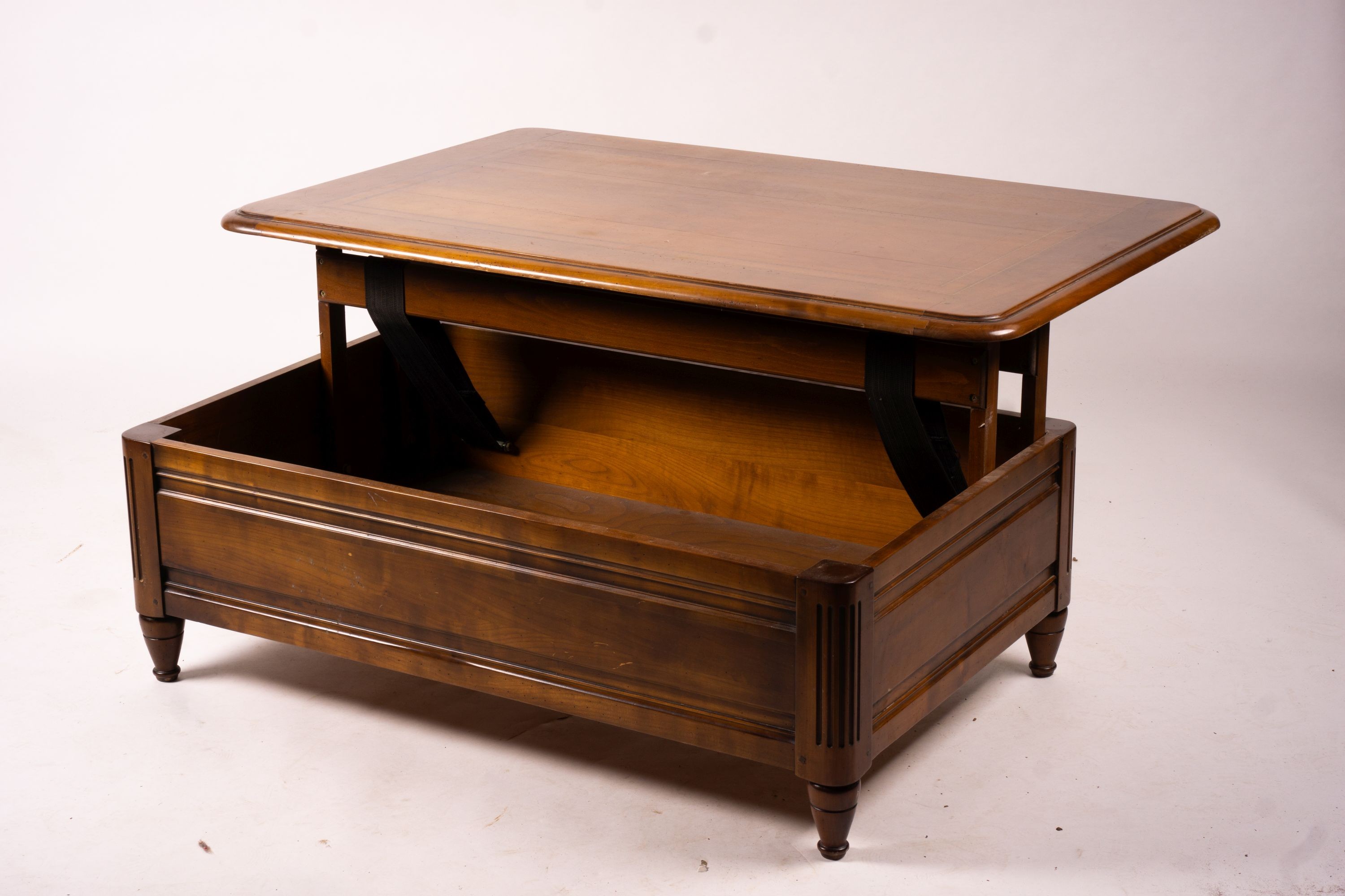 A reproduction rectangular walnut coffee table with rising top enclosing a wine bottle storage interior, length 130cm, depth 85cm, height 41cm